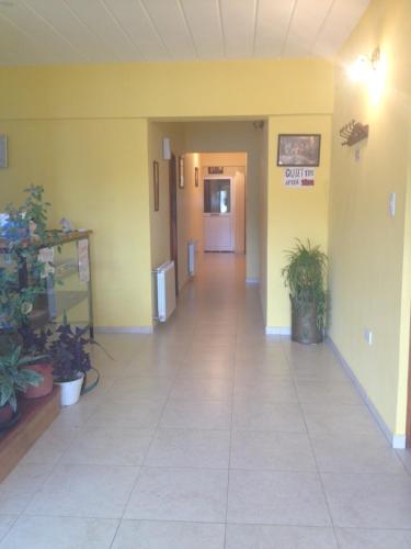 
a room with a door open and a door to a hallway at Hostel Los Viajeros in El Chalten
