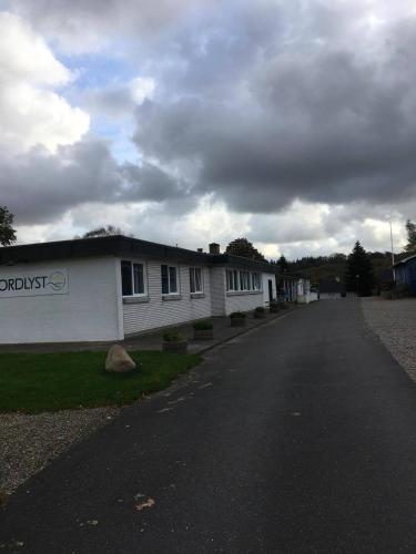 an empty street in front of a white building at Fjordlyst Hotel in Aabenraa