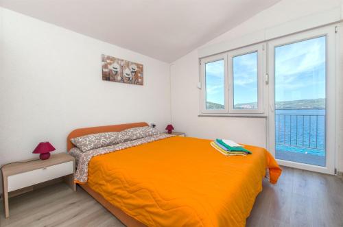 Postel nebo postele na pokoji v ubytování Apartments Na Obali Mora