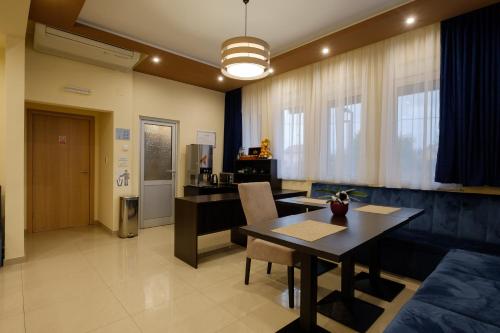 a living room filled with furniture and a table at Airport Hotel Garni in Belgrade