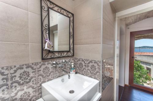 a bathroom with a sink and a mirror at House Stone house island Prvic in Prvić Šepurine