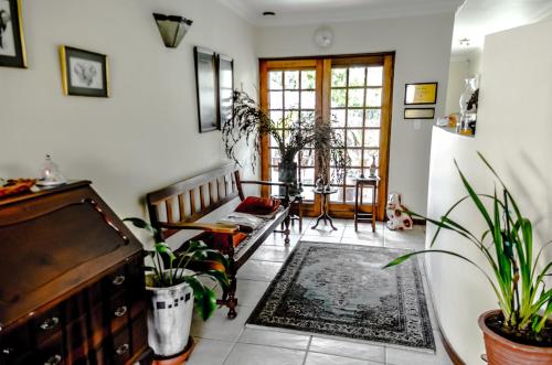 a living room with a couch and some plants at Dolliwarie Guesthouse in Panorama