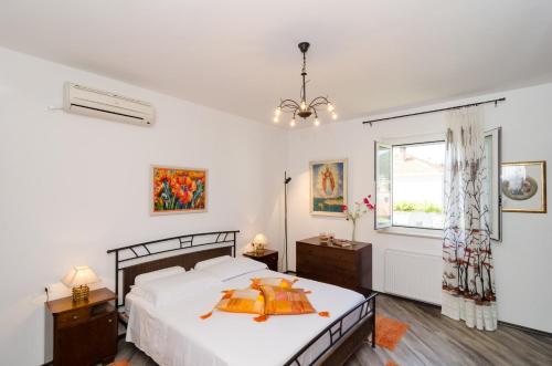 a bedroom with a bed and a window at Apartment Veve in Dubrovnik