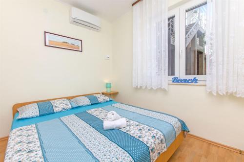 Postel nebo postele na pokoji v ubytování Apartments Zecic