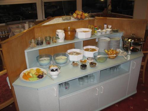 a buffet with bowls and plates of food on it at Hotel Restaurant Escher in Leukerbad