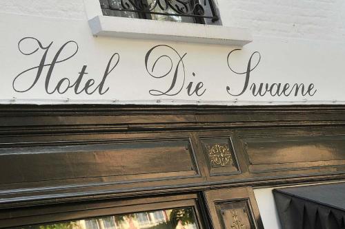 a sign on a building with a picture of a man on it at Boutique Hotel Die Swaene in Bruges