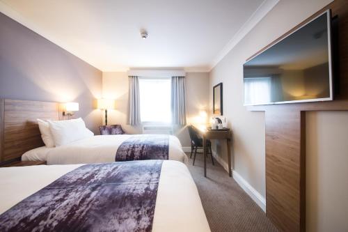 a hotel room with two beds and a window at Toby Carvery Old Windsor by Innkeeper's Collection in Windsor