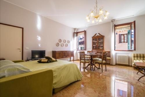 um quarto com uma cama e uma sala de jantar em Rialto Bridge Large Venetian Style With Lift em Veneza