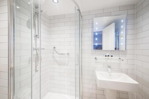 a white bathroom with a sink and a shower at Toby Carvery Old Windsor by Innkeeper's Collection in Windsor