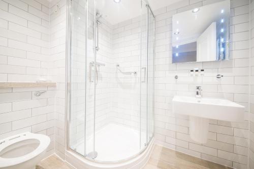 a bathroom with a shower and a toilet and a sink at Toby Carvery Old Windsor by Innkeeper's Collection in Windsor