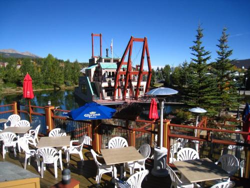 a deck with tables and chairs and a roller coaster at Der Steiermark in Breckenridge