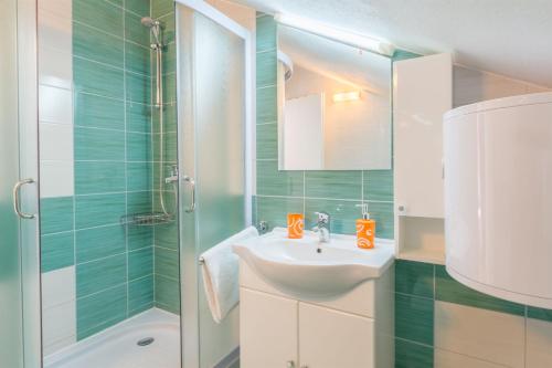 a bathroom with a sink and a shower at Apartment Ante in Milna