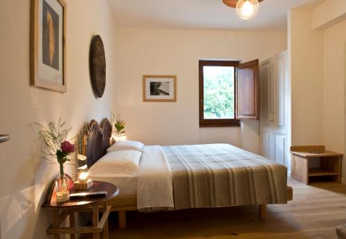 a bedroom with a bed and a table and a window at Cincinnato Wine Resort in Cori