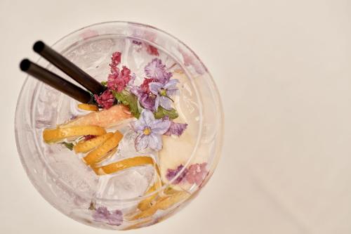 a glass bowl of food with flowers and chopsticks at Villa di Piazzano - Small Luxury Hotels of the World in Cortona