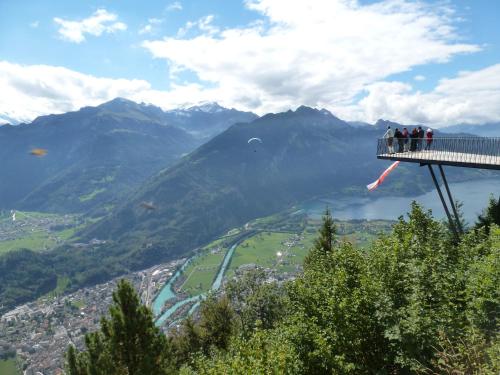 a group of people on a viewing platform overlooking a mountain at Loveroom in Interlaken