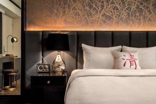 a bed with a white comforter and pillows at Cachet Boutique Hotel NYC in New York