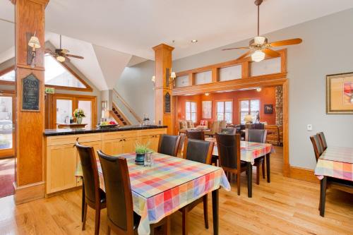 a dining room with tables and chairs and a kitchen at The Bradley Boulder Inn in Boulder