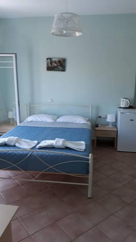 a bedroom with a bed with towels on it at Olympic View Guesthouse in Kalami