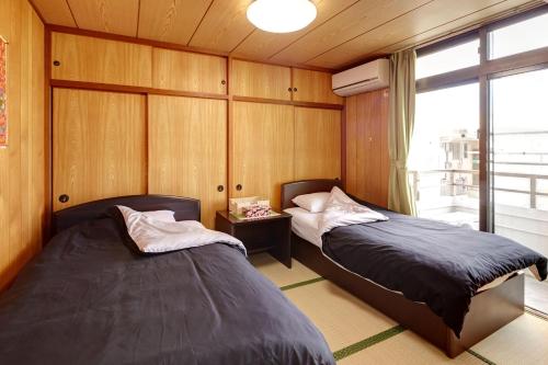 Postel nebo postele na pokoji v ubytování Condominium Aoi Sanmyaku