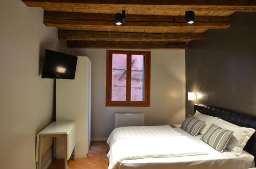1 dormitorio con 2 camas y ventana en Tiepolo Charme Houses, en Venecia