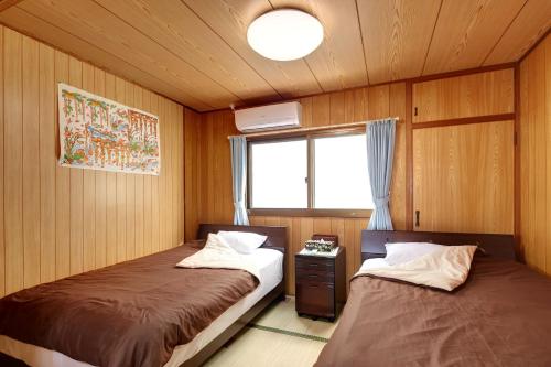 A bed or beds in a room at Condominium Aoi Sanmyaku