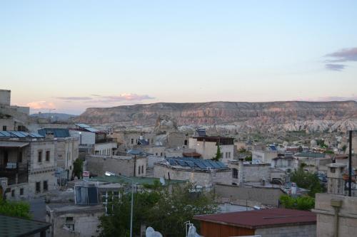 a view of a city with mountains in the background at Coco Cave in Goreme