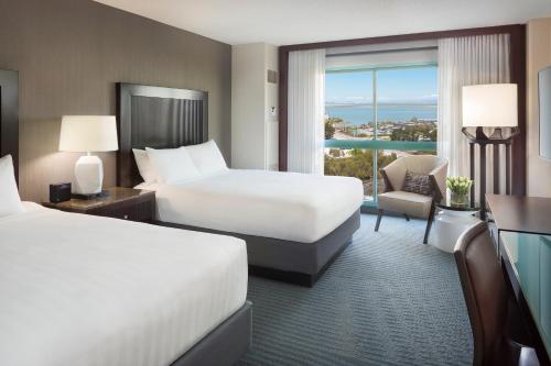 a hotel room with two beds and a large window at Hyatt Regency San Francisco Airport in Burlingame