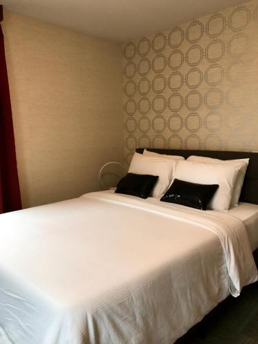 Una cama o camas en una habitación de Hotel Mimosa