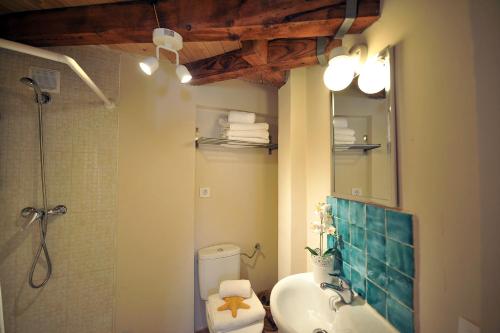 a bathroom with a sink and a toilet and a mirror at Cathedral Suite in Toledo