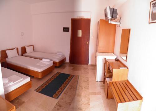 a living room with two beds and a couch at Samaria in Agia Roumeli
