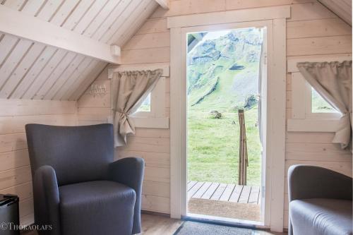 a living room filled with furniture and a window at Glamping & Camping in Vestmannaeyjar