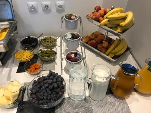 a counter topped with bowls of fruit and other food at Hotel Grad in Sarajevo