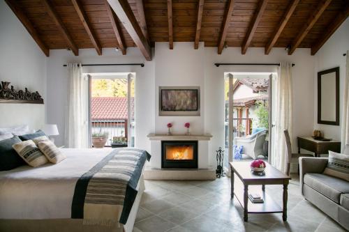 a bedroom with a bed and a fireplace at Casale Panayiotis in Kalopanayiotis