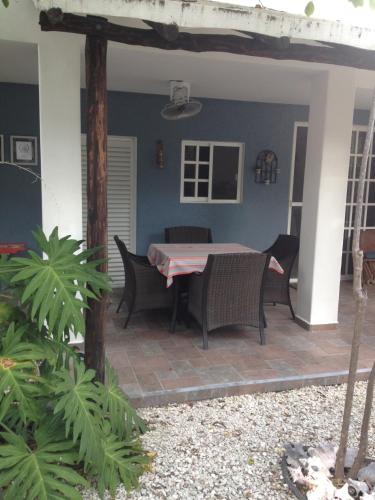 a patio with a table and chairs on it at Villa Escondida Guest House Cozumel Downtown in Cozumel