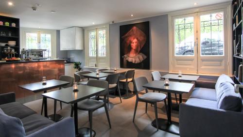 a restaurant with tables and chairs and a painting on the wall at No. 377 House in Amsterdam