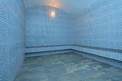 a corner of a room with blue walls and a tile floor at Eco Garden Residences in Phnom Penh