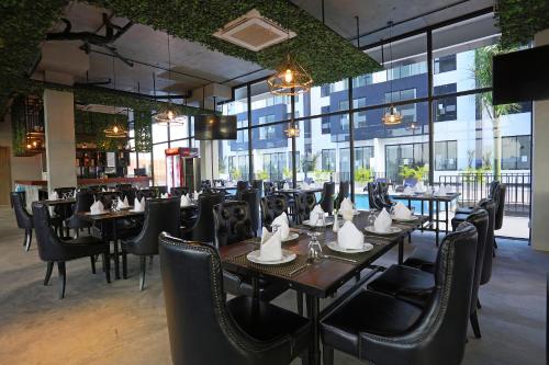 a restaurant with tables and chairs with a dog sitting at them at Eco Garden Residences in Phnom Penh
