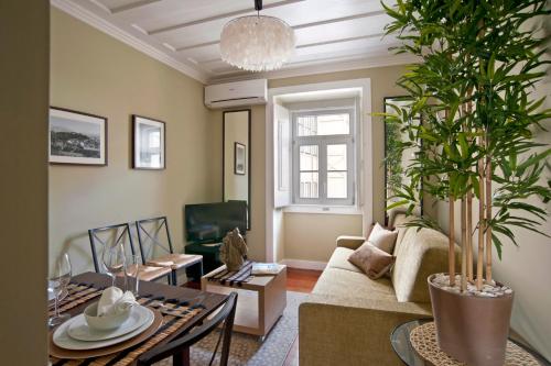 a living room with a couch and a table at Lisbon Colours Bairro Alto Apartments in Lisbon