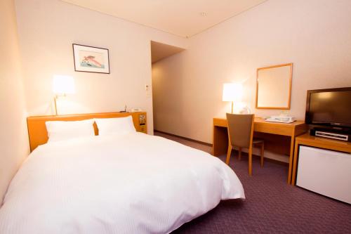 Postel nebo postele na pokoji v ubytování Hotel Ikkeikaku