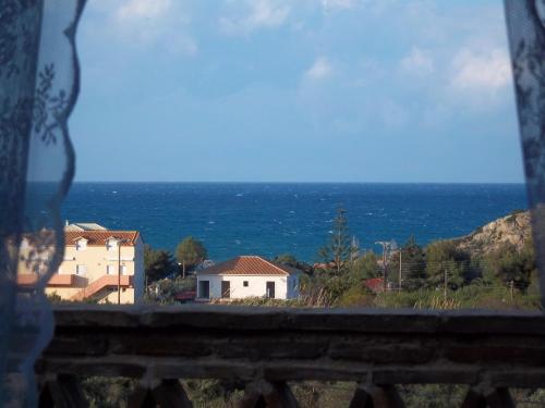 a view of the ocean from a window at Alegria Villas Complex in Vasilikos