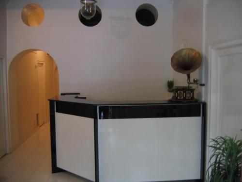 a kitchen with a large white and black counter at Hotel Plaza (BOOKING FOR FOREIGN TOURIST ONLY) in Jālgaon