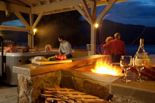 a group of people standing around a fire pit at Black Bear Inn in Ketchikan