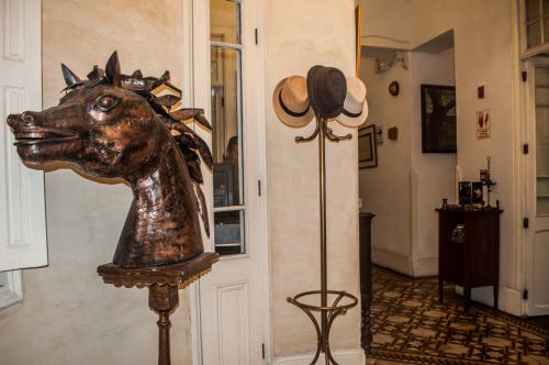 a statue of a horse on a stand in a hallway at Casa Falleri Boutique Hotel in Lima
