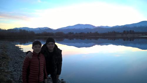 two people standing in front of a lake at Mt Dobson Motel in Kimbell