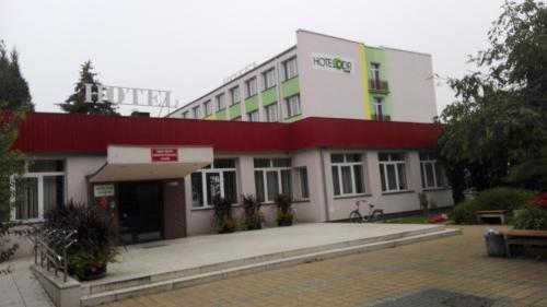 a large white building with a red roof at HOTEL ODR in Sulechów