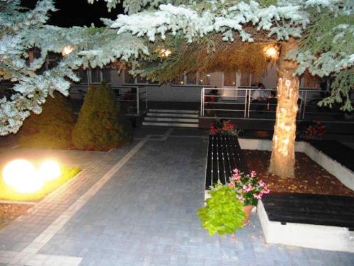 a park with a bench and trees and lights at HOTEL ODR in Sulechów