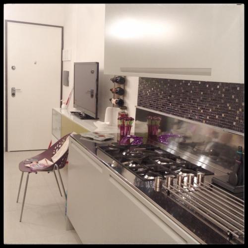 a kitchen with a stove and a counter top at Il riposo dei Giganti in Càbras