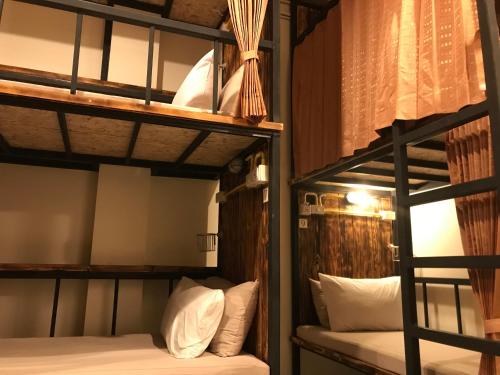 a couple of bunk beds in a room at B&B hostel @ Jomtien in Jomtien Beach