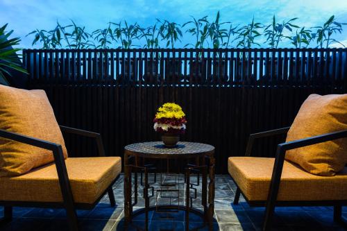 a table with a vase of flowers on a balcony at Golden Temple Boutique in Siem Reap