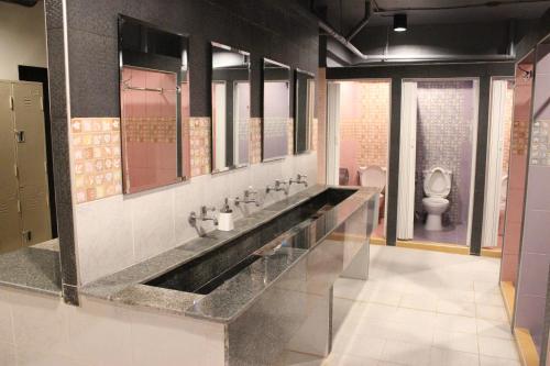 a bathroom with a large sink and a toilet at B&B hostel @ Jomtien in Jomtien Beach